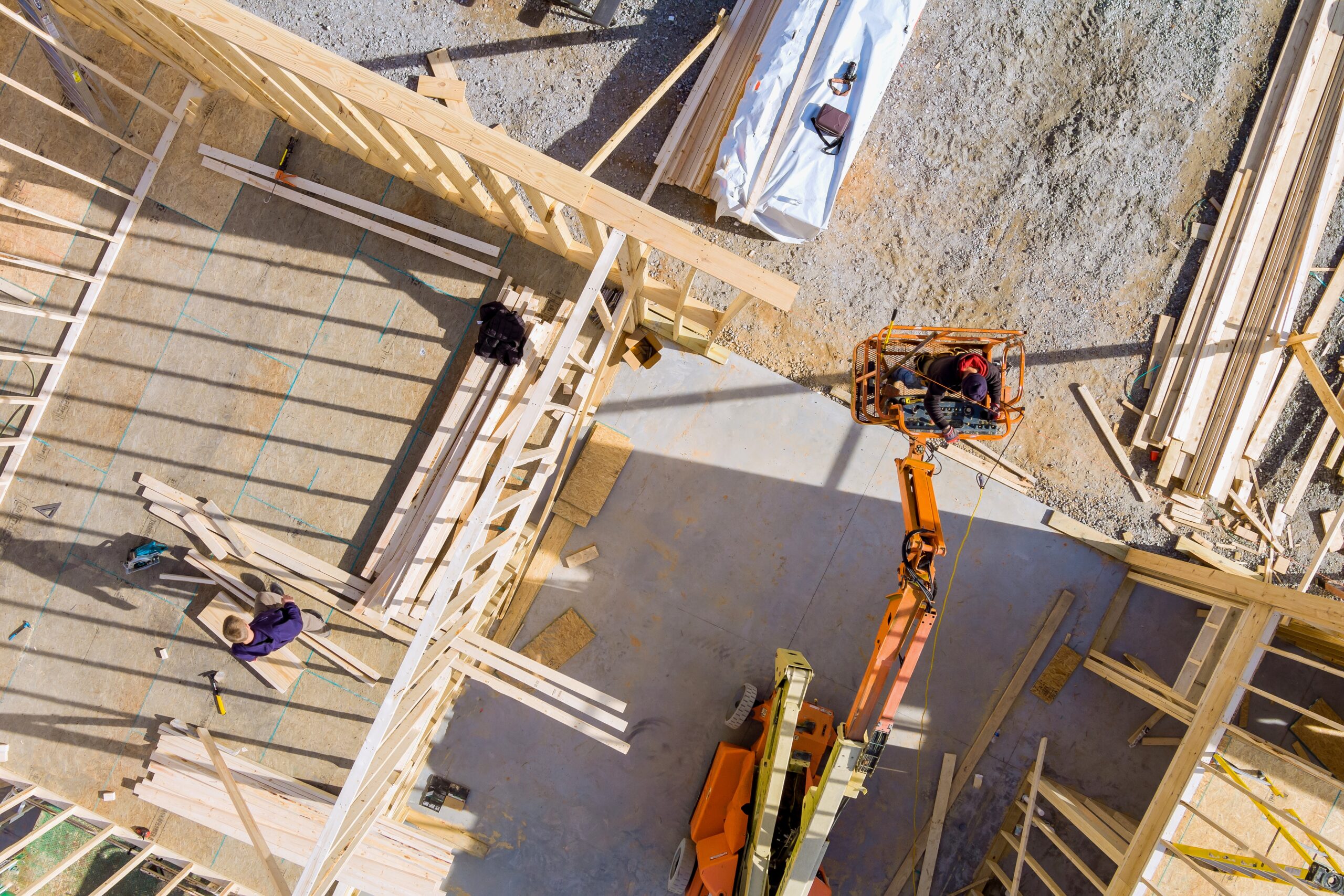 Wood building frame on new residential construction home framing home a boom truck forklift in the new home